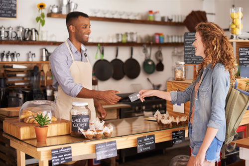 small business owner taking payment from customer